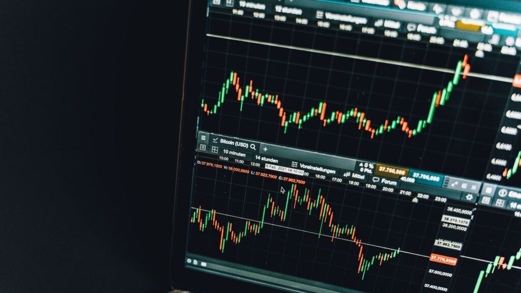 Analyst reviewing financial charts with a magnifying glass