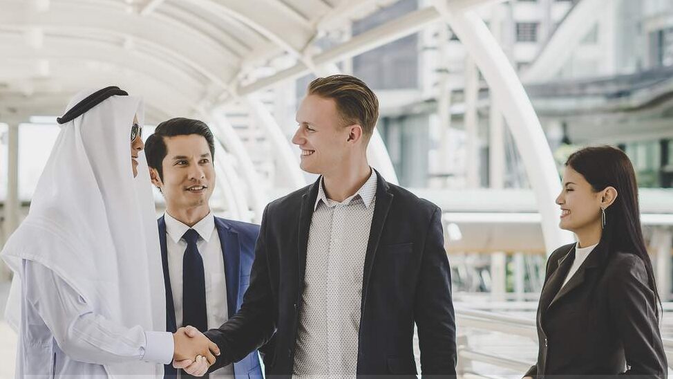 Business partners shaking hands in an office setting